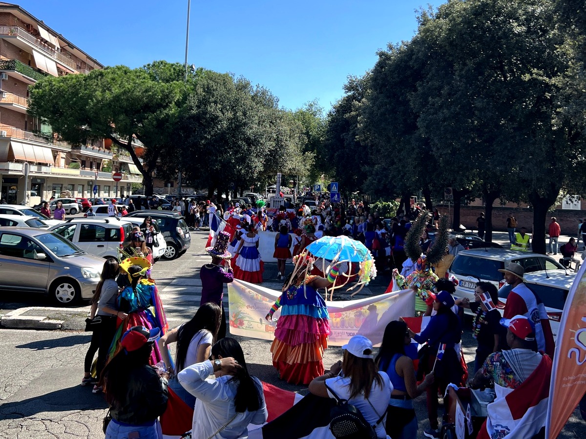 Dominican community members gathered with flags at a cultural celebration.